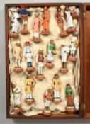 A COLLECTION OF SEVENTEEN POOSA COMPANY SCHOOL POTTERY FIGURES, mostly 4ins high, in a mahogany