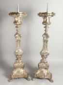 A GOOD PAIR OF SILVER PLATED CANDLESTICKS. 30ins high.