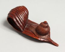 A JAPANESE CARVED WOOD SNAIL ON A LEAF. 4.5ins long