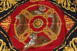 A SALVATORE FERRAGAMO SILK SCARF, multi coloured, red, blue, yellow etc with tigers. 68ins x 68ins.