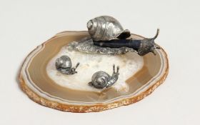 A GROUP OF RUSSIAN SILVER SNAILS on an agate base.