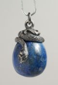 A RUSSIAN SILVER AND CARVED LAPIS EGG PENDANT.