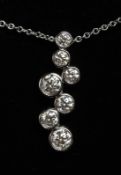 AN 18CT WHITE GOLD SEVEN STONE BUBBLE DIAMOND PENDANT AND CHAIN.