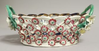 AN 18TH CENTURY WORCESTER PIERCED BASKET, painted with exotic birds on a blue scale ground,