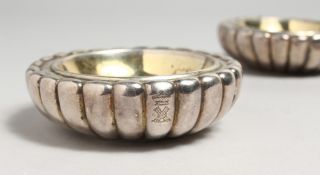 A PAIR OF GEORGE III FLUTED CIRCULAR SALTS. 3.5ins diameter, London, 1805. Maker W. B. & R.S.