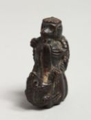 A CARVED WOOD FROGS NETSUKE.