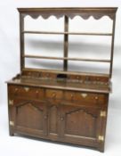 A GOOD 18TH CENTURY OAK DRESSER, the Delft rack with a moulded cornice and shaped frieze over two