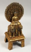 A GILT BRONZE GOD, sitting on two lions, 11ins high.