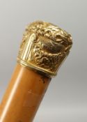 A 19TH CENTURY CANE with possibly, gold top, hung with garlands, opening to reveal a whisky tot.