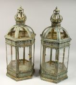 A PAIR OF CIRCULAR METAL AND GLASS HEXAGONAL LANTERNS, 27ins high.