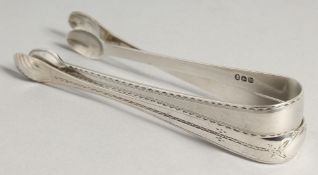TWO GEORGE III BRIGHT CUT SUGAR TONGS, S A London 1784.