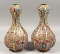 A GOOD PAIR OF BULBOUS OCTANGONAL SHAPED MILLEFIORE DESIGN PORCELAIN VASES.
