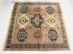 A PERSIAN PINK GROUND ARDABIL CARPET, with three large central medallions. 6ft 4ins x 6ft 6ins.