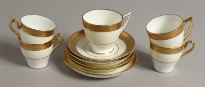 A SET OF FIVE MINTON HARLEQUIN COFFEE CUPS AND SAUCERS with acid etched gilded bands, various