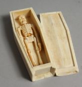 A BONE COFFIN & SKELETON. 4.5ins long.