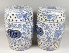 A PAIR OF CHINESE BLUE AND WHITE BARREL SEATS, 17ins high.