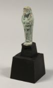 AN EGYPTIAN SHABTI on stand, 3ins high.