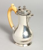 AN 18TH CENTURY SILVER JUG with ivory handles. 5.5ins high.