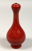 A SMALL CHINESE RED OVIOD SHAPED VASE, mark in blue, 7ins high.