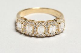 AN 18CT. YELLOW GOLD EMERALD CUT DIAMOND HALF HOOP RING