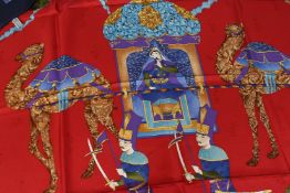 A SALVATORE FERRAGAMO SILK SCARF, red and blue labels. 68ins x 68ins.