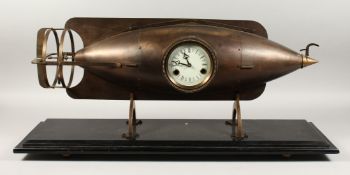 A GOOD BRONZE TORPEDO SHAPED CLOCK, with circular dial on a marble base. 30ins long.