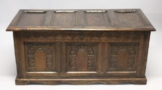 AN 18TH CENTURY OAK COFFER with a panelled top and triple panelled front, carved with arches. 4ft