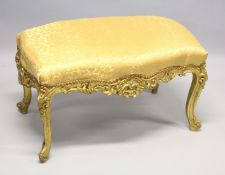 A GILT FRAMED WINDOW SEAT with yellow cover. 3ft wide
