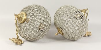 A PAIR OF CRYSTAL BALL LIGHTS,12ins wide, metal chain.