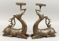 A PAIR OF CHINESE BRONZE DEER STICKS, 13ins high.