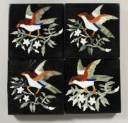 A SET OF FOUR BLACK MARBLE TILES inlaid with birch and foliage. 4ins square.