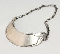 A CONTINENTAL SILVER .830 CRESCENT WINE LABEL.