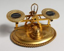 A GOOD SET OF ORMOLU SCALES AND WEIGHTS, the balances inset with tigers eye panels, with allover