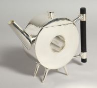 A CHRISTOPHER DRESSER DESIGN CIRCULAR TEA POT with a hole.