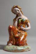 A CSERF POTTERY NUDE OF A YOUNG SEATED WOMAN, holding a bird. Signed. 1928. 10.5ins high.