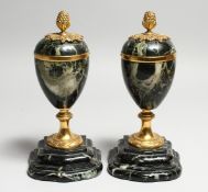 A GOOD PAIR OF 19TH CENTURY FRENCH MARBLE URNS, with pineapple finials. 8.5ins high.