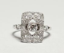 AN ART DECOO STYLE 18CT WHITE GOLD TABLET RING, set with diamonds.