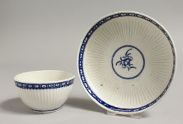 AN 18TH CENTURY TEABOWL AND SAUCER painted in blue with Dark Sprig Centre, crescent mark.