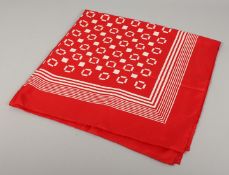 AN YVES ST. LAURENT SILK SCARF. Red with white pattern. 34ins x 36ins.