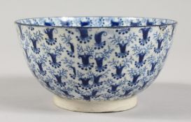 A 19TH CENTURY BLUE AND WHITE BOWL, painted all over with a stylised floral design. 4.5ins