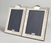 A PAIR OF FLUTE DESIGN SILVER PHOTOGRAPH FRAMES. 7.5ins x 5.5ins