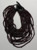 A GERAD LYNGGARD HORN NECKLACE in a white bag.