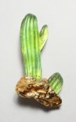 A DAUM GILT QAND GLASS CACTUS BROOCH. 3ins long.