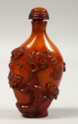 A CHINESE CARVED AMBER SNUFF BOTTLE