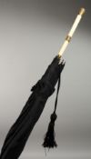 AN EDWARDIAN PARASOL with gold mounted ivory handle. 35ins long.