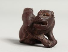 A CARVED WOOD FO DOG AND PUPPY