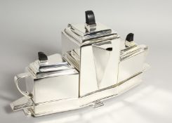 A CHRISOPHER DRESSER THREE PIECE TEA SET ON A STAND.