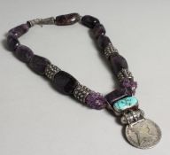 AN AMETHYST, TURQUOISE AND SILVER THERESIAD NECKLACE, set with a coin. Maker Arlene Coyne