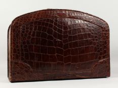 A GOOD, VINTAGE ASPREY OF LONDON, CROCODILE SUIT CASE, with velvet interior and bow front. 24ins