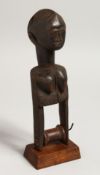 A LARGE TRIBAL CARVED WOOD PULLEY as a female figure. 10.5ins high.